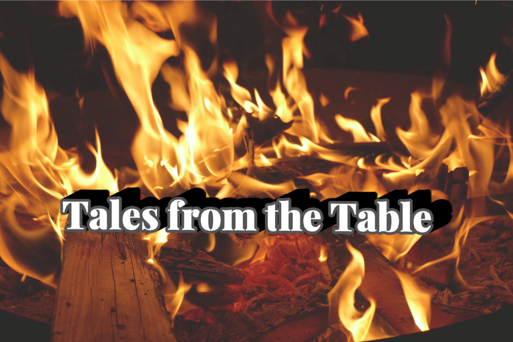 The words 'Tales from the Table' in white text and a deep black shadow, over a picture of a campfire.